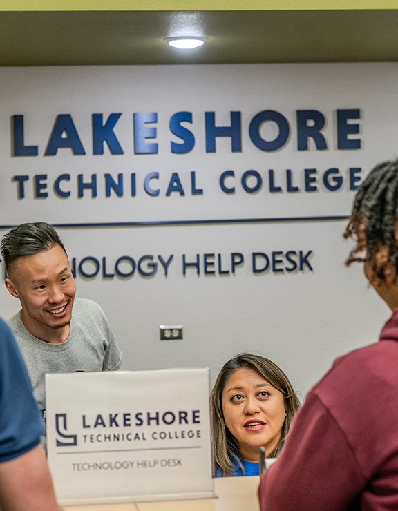 People standing around a desk