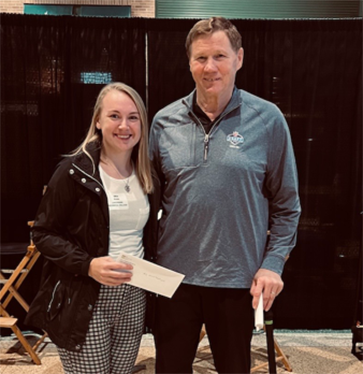 Erin Rank accepts her scholarships from Green Bay Packers President Mark Murphy.