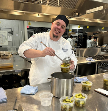 Shawn Engel enjoys his Garde Manger course during the spring 2024 semester.