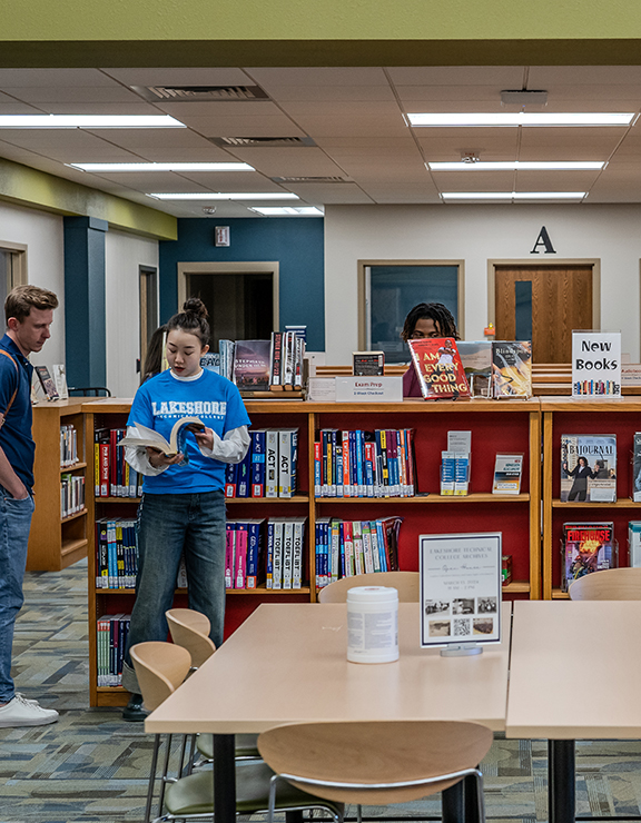 People reading a book in a library