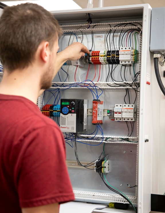 Student in front of an electric panel