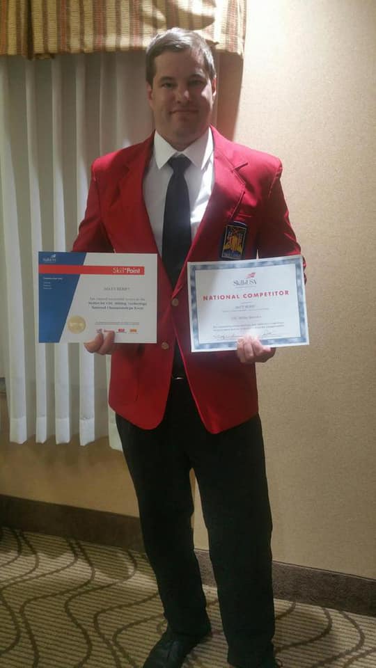 Matt Berry, Lakeshore Technical College student, holding his national CNC milling awards.