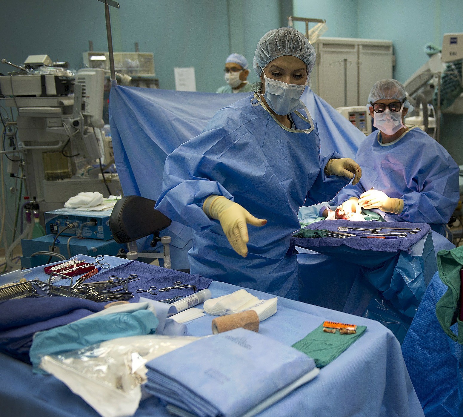 Nurses assisting with surgery on a patient