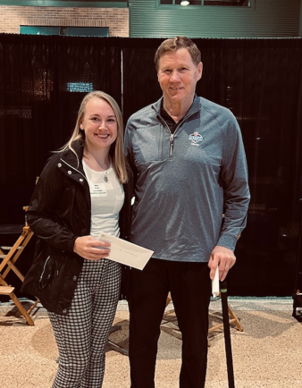 Erin Rank accepts her scholarships from Green Bay Packers President Mark Murphy.